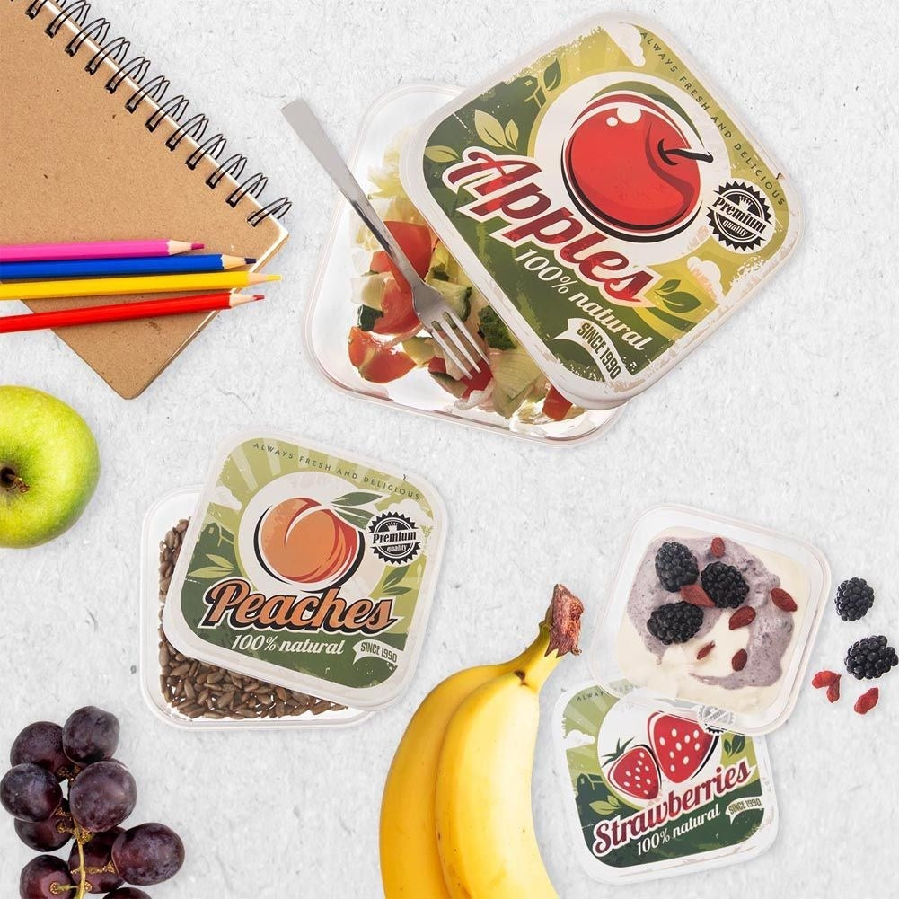 Fyra matlådor med fruktmotiv i olika storlekar